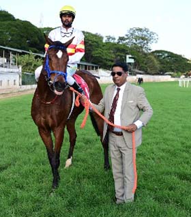 Beautiful Bloom (M Prabhakaran up), winner of the FANTASY DREAM PLATE (DIV-I) being led in by trainer Bobby M on Wednesday races at Mysore.